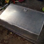 Custom fuel tank designed to be maximize the area of the trunk floor